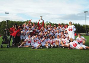 Head Coach Tim Murdoch hoists the Baggataway Cup, as the Redmen celebrate their title. (Kevin Caplice)