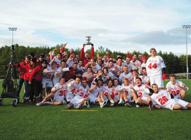 Head Coach Tim Murdoch hoists the Baggataway Cup, as the Redmen celebrate their title. (Kevin Caplice)