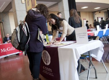 The Canadian College of Naturopathic Medicine booth at the SUS grad school fair. (Simon Poitrimolt / McGill Tribune)