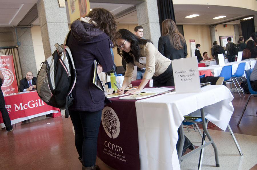 The Canadian College of Naturopathic Medicine booth at the SUS grad school fair. (Simon Poitrimolt / McGill Tribune)