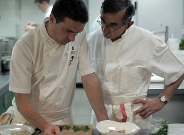 Sébastien focuses on whipping up culinary magic, while enduring father Michel’s whithering gaze. (www.twi-ny.com)