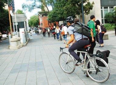 student bikes on campus