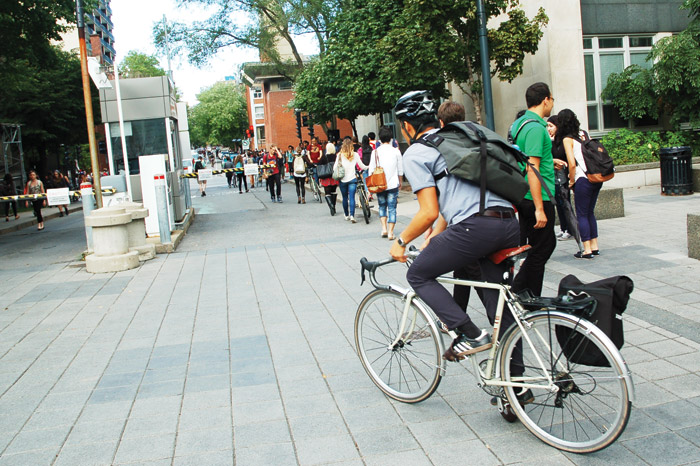 student bikes on campus