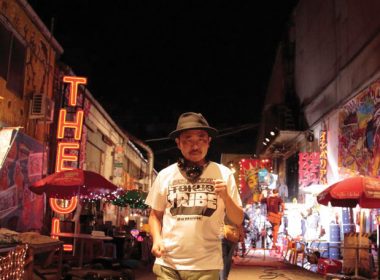 Director Sion Sono stands in the streets of Tokyo